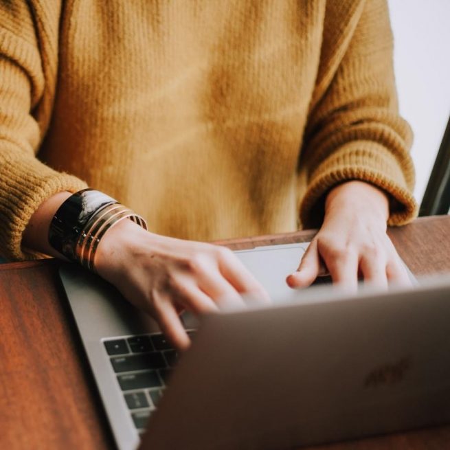 Lady on laptop, using hotel's free WiFi