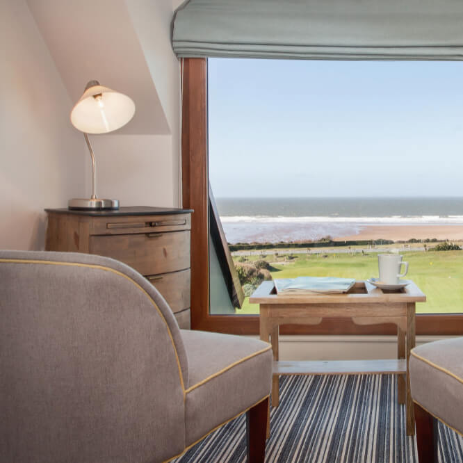 Seating area and beach view from room in Woolacombe Bay