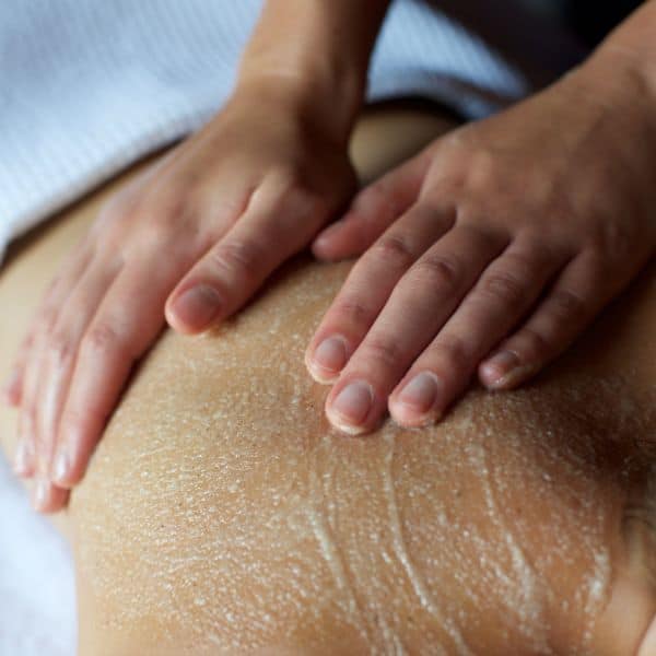 Woman having body scrub