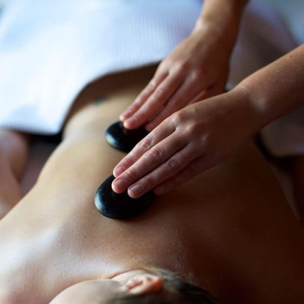 Woman having hot stone massage