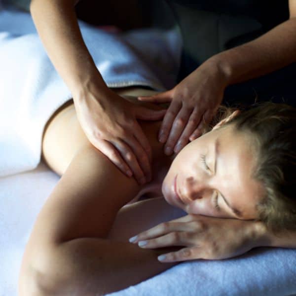 Woman in a white towel having a massage